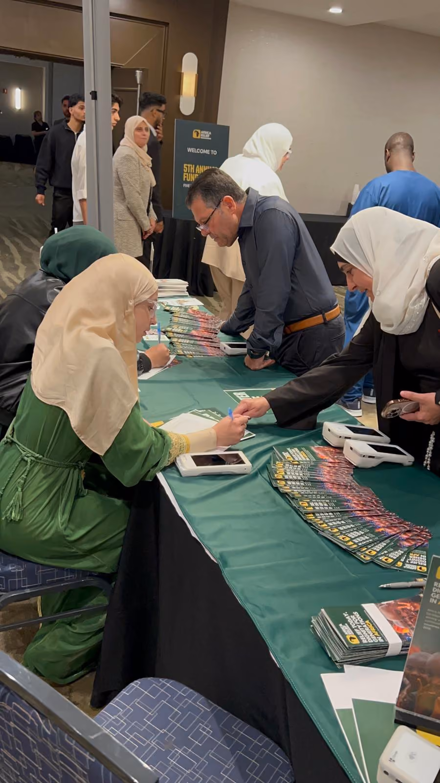 Guests at the branded registration and pledge desk