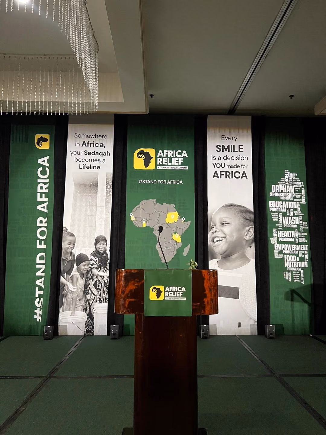 Stage with branded multi-panel backdrop and podium