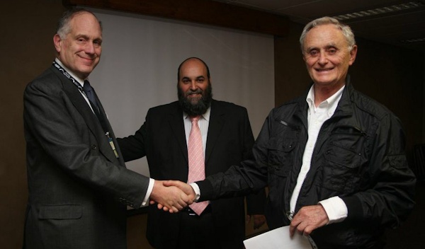 Mervyn Smith (r) shaking hands with Ronald S. Lauder and Rabbi Moshe Silberhaft