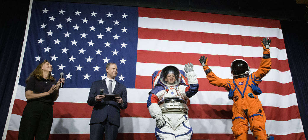 Amy Ross, a spacesuit engineer at NASA’s Johnson Space Center, left, and NASA Administrator Jim Bridenstine, second from left, watch as Kristine Davis, a spacesuit engineer at NASA’s Johnson Space Center, wearing a ground prototype of NASA’s new Exploration Extravehicular Mobility Unit (xEMU), and Dustin Gohmert, Orion Crew Survival Systems Project Manager at NASA’s Johnson Space Center, wearing the Orion Crew Survival System suit, right. Photo Credit: (NASA/Joel Kowsky)