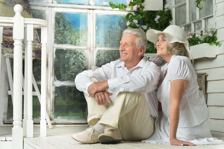 Portrait of beautiful elderly couple on wooden porch