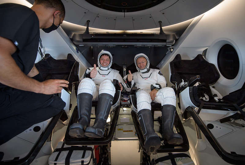 NASA astronauts Robert Behnken, left, and Douglas Hurley are seen inside the SpaceX Crew Dragon Endeavour spacecraft onboard the SpaceX GO Navigator recovery ship shortly after having landed in the Gulf of Mexico off the coast of Pensacola, Florida, Sunday, Aug. 2, 2020. The Demo-2 test flight for NASA’s Commercial Crew Program was the first to deliver astronauts to the International Space Station and return them safely to Earth onboard a commercially built and operated spacecraft. Behnken and Hurley returned after spending 64 days in space. Photo Credit: (NASA/Bill Ingalls)