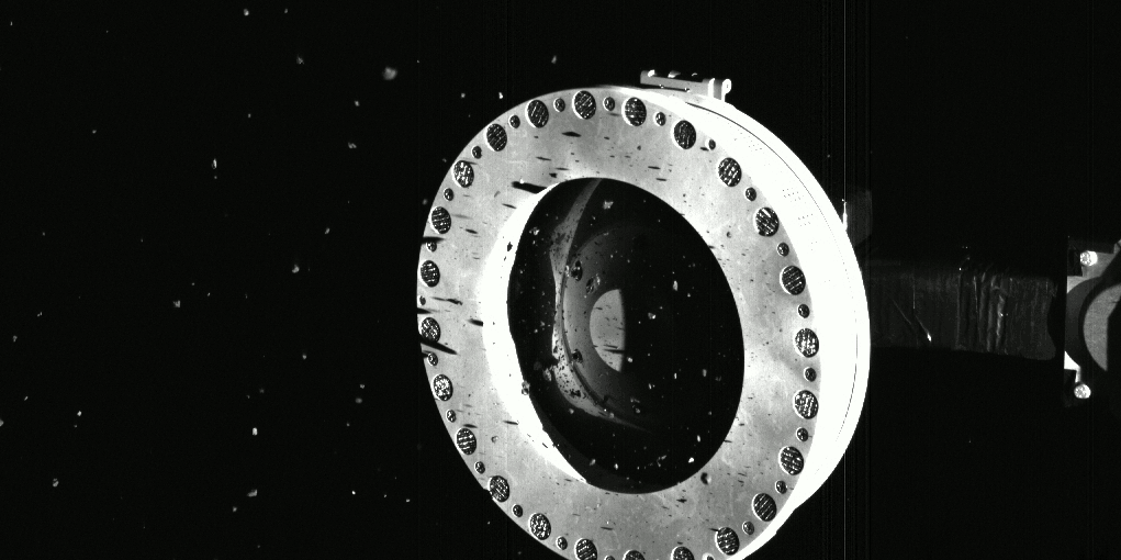 Captured on Oct. 22, this series of three images shows that the Touch-and-Go Sample Acquisition Mechanism (TAGSAM) head on NASA’s OSIRIS-REx spacecraft is full of rocks and dust collected from asteroid Bennu. The image series also shows that some of these particles are slowly escaping the sampler head. Photo: NASA/Goddard/University of Arizona