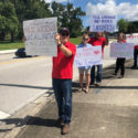 Ledger workers hold signs in Lakeland