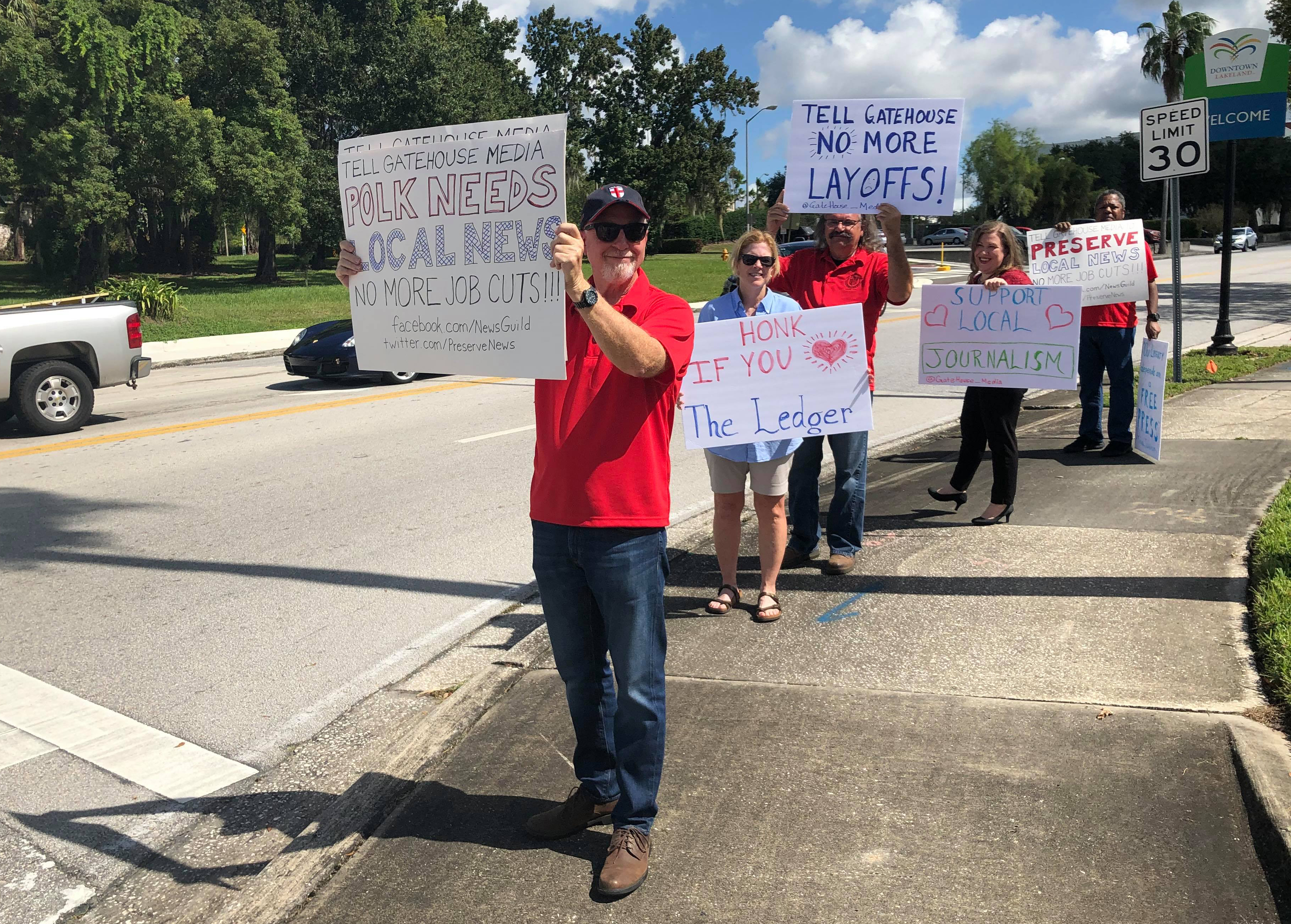 Ledger workers hold signs in Lakeland