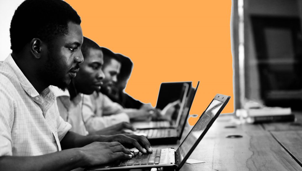 Group of students working on computers all at desks