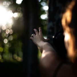 girl reaching towards the sunlight