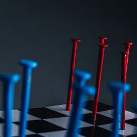 red and blue nails on chessboard