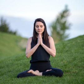 woman doing yoga in a field
