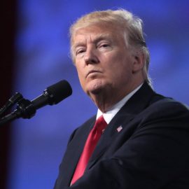 Donald Trump's testimony as he speaks on stage into a microphone.