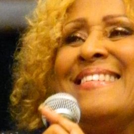 Darlene Love holding a microphone.