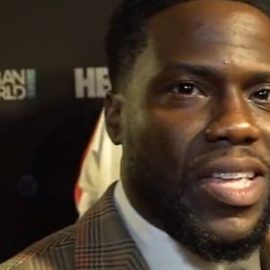 The famous comedian Kevin Hart speaking at a red carpet event.