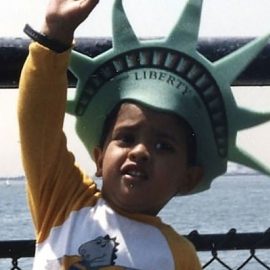 Vivek Ramaswamy as a child wearing a Statue of Liberty hat.