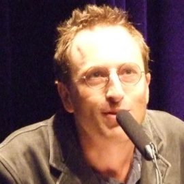 Journalist Jon Ronson talking into a microphone