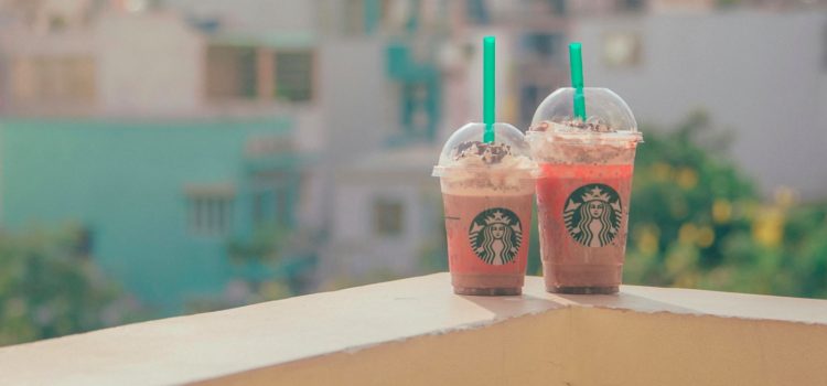 The Innovation Strategy of Starbucks That Saved the Company Two new Starbucks drinks on a ledge as part of the innovation strategy at Starbucks