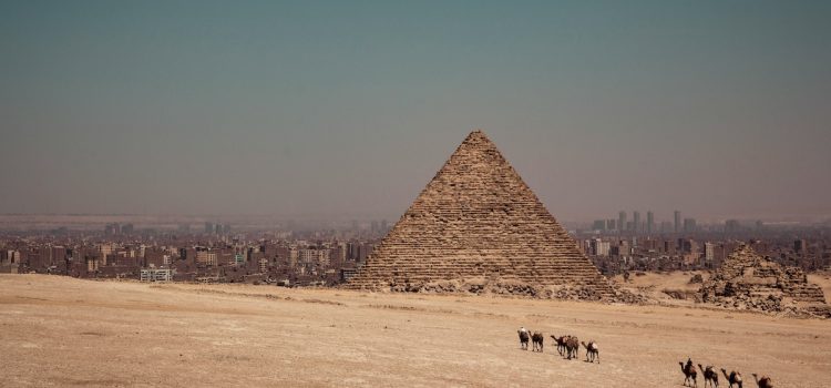 Ray Dalio: The Rise and Fall of Empires Reveal History’s Cycles An ancient pyramid in Egypt with modern cities in the distance illustrates the rise and fall of empires