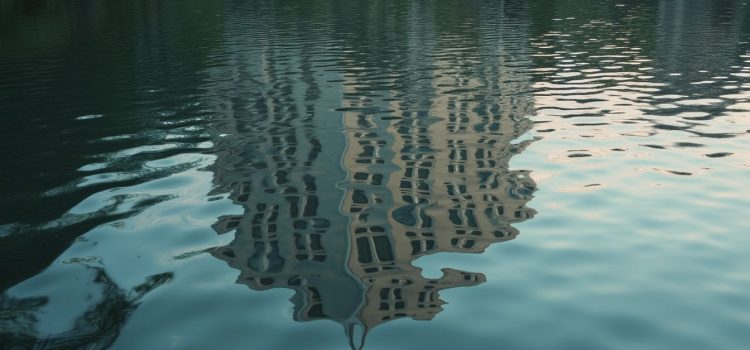 Perception and Experience: How Our Brains Distort Reality A distorted reflection of a building in a rippling lake illustrates faulty perception and memory of reality