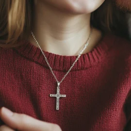 A man holding his partner who is wearing a cross necklace, representing spirituality and sexuality