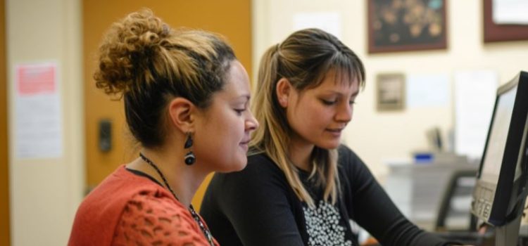 Building Professional Relationships: Quantity Over Quality Two women building a professional relationship by helping each other at their desks