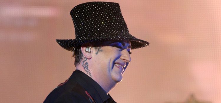Where Is Boy George Now? Personal Details From His Memoir Boy George smiling on stage in Sydney illustrates the question, "Where is Boy George now?"
