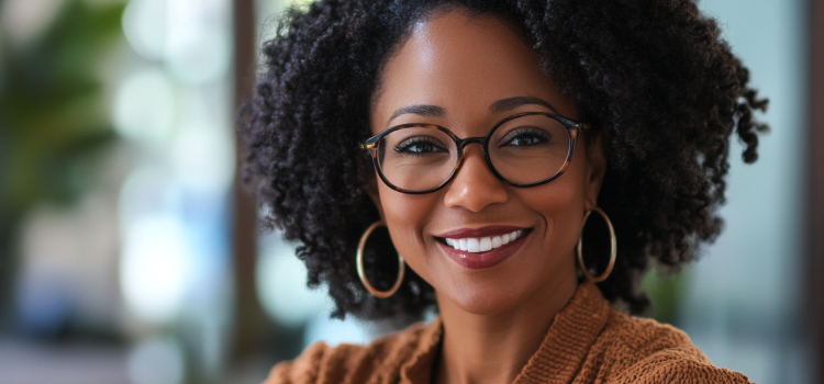 A female manager wearing glasses who shows resilience as a leader