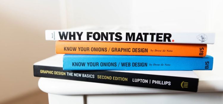 A stack of books on a table with titles that relate to visual formatting