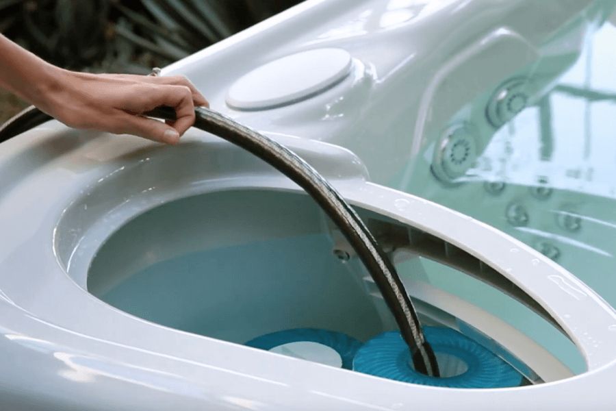How to Use the FreshWater Salt System - HotSpring Spas of Dayton A Hose Fills A Hot Tub