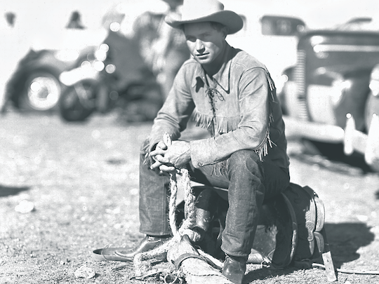 photograph of soldier and rodeo cowboy Fritz Truan sitting on his bronc saddle