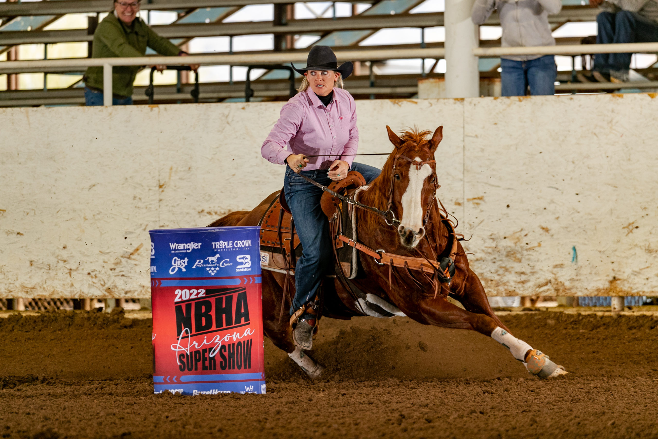 Girl riding barrel horse at rodeo