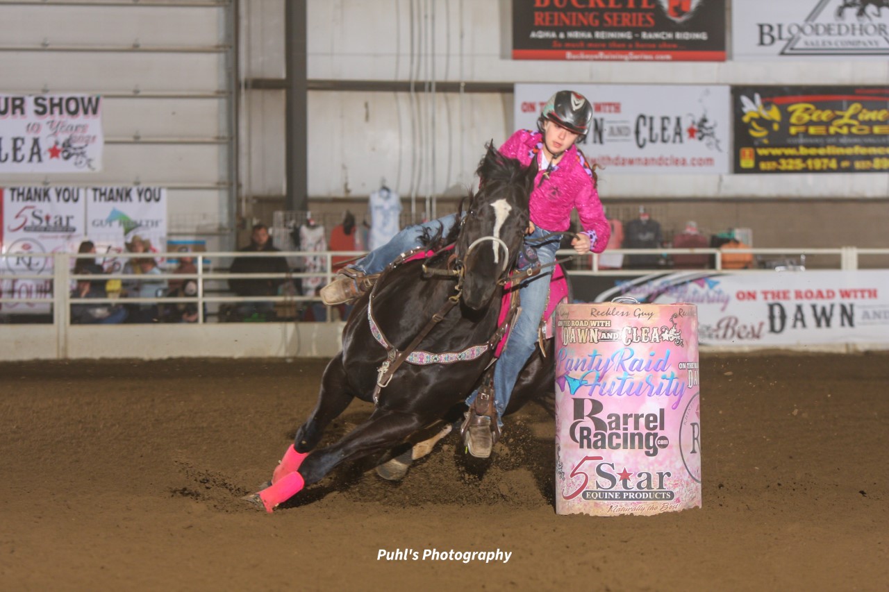 youth barrel racer Nina Shirey turning a barrel on her barrel horse