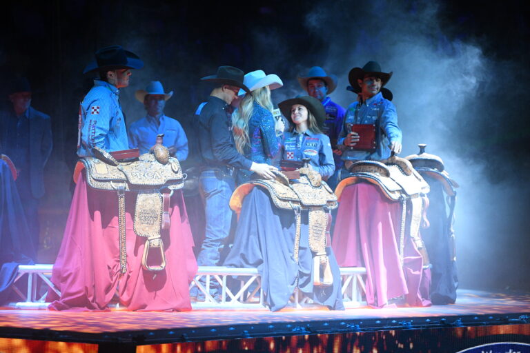 Hailey Kinsel accepts her fourth barrel racing world championship at NFR 2022.
