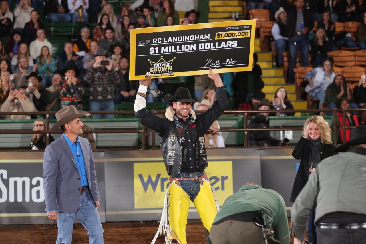 Bareback rider RC Landinghma holds up his $1,000,000 check at the WCRA' Cowtown Christmas Championship.