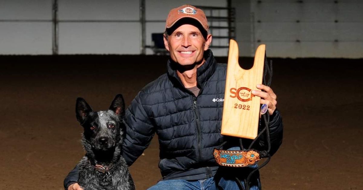 Mark Bugni smiles for a win photo with his dog