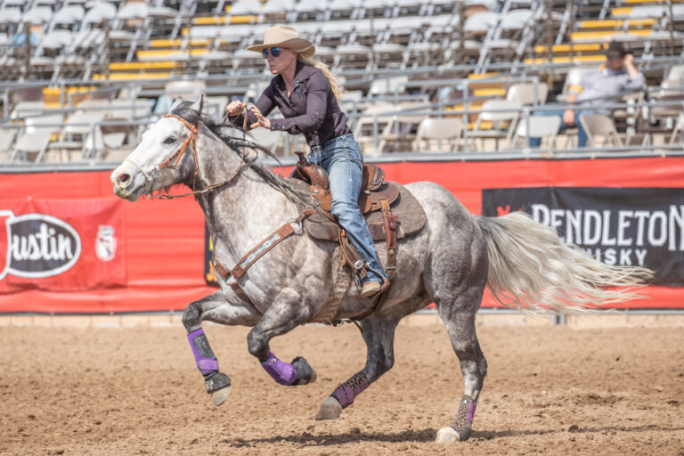 barrel horse running between the first and second turn