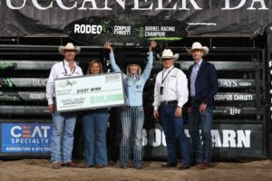Sissy Winn poses with the championship surfboard and $15,000 check in Corpus Christi.