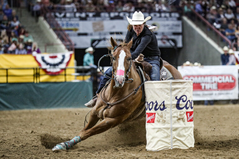 Sara Winkelman turns a barrel at Snake River Stampede Rodeo.