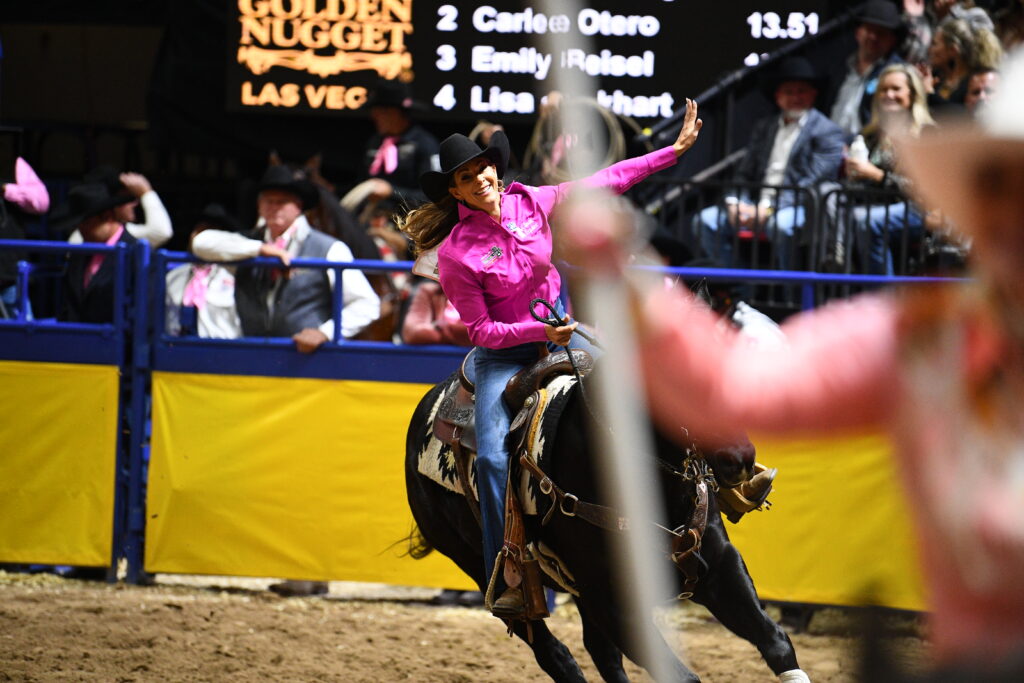 Kassie Mowry waves to NFR crowd during victory lap