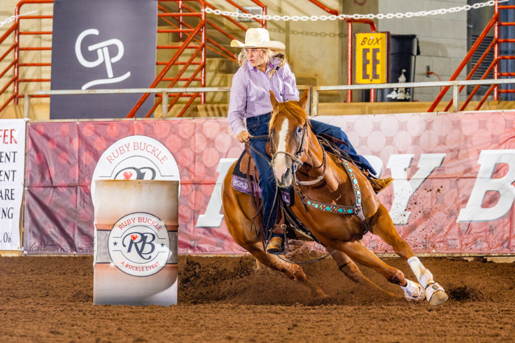 Rhaylen Maloy turning a barrel on her horse