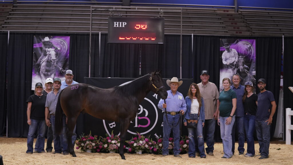 Thee Ironman poses with his buyers 