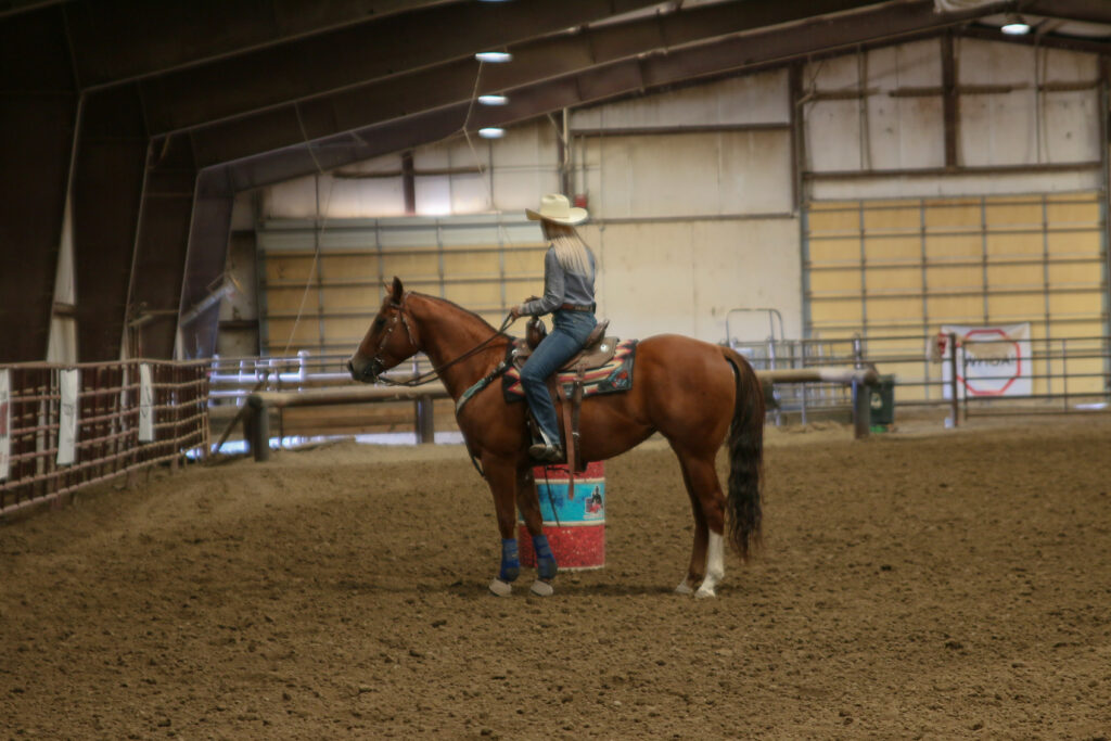 Amy sets up a barrel racing drill on a horse