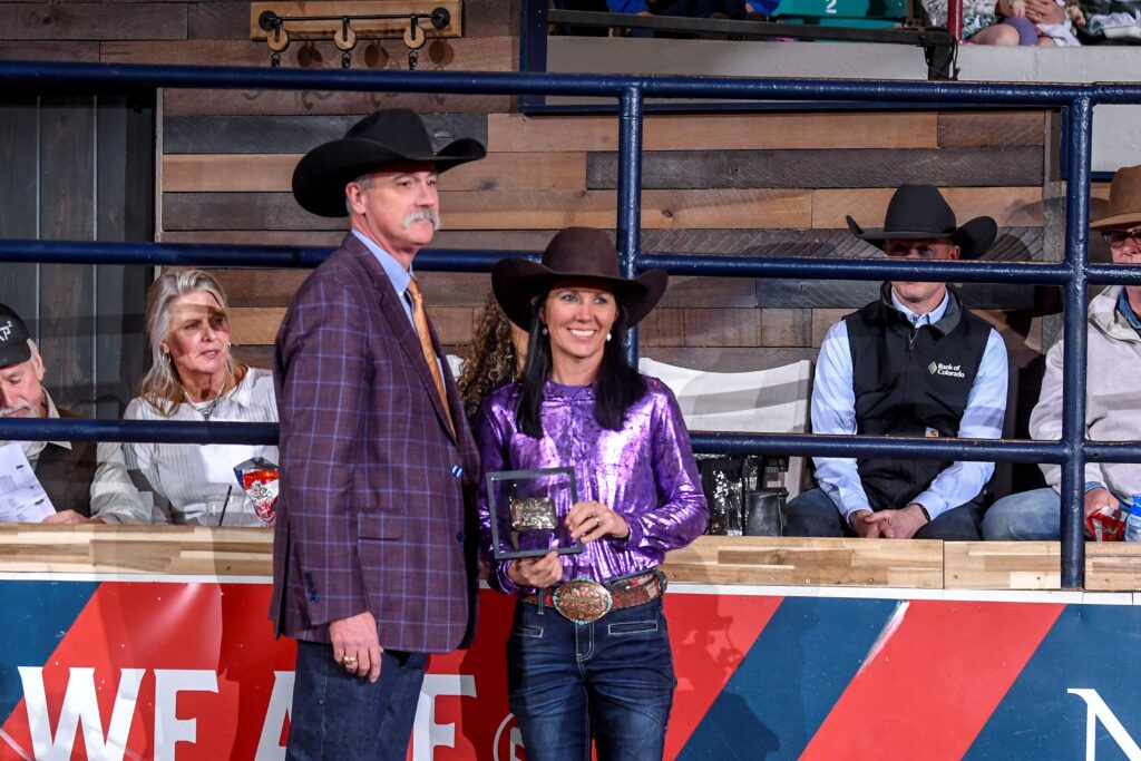 Heidi Gunderson receives buckle for winning Denver rodeo