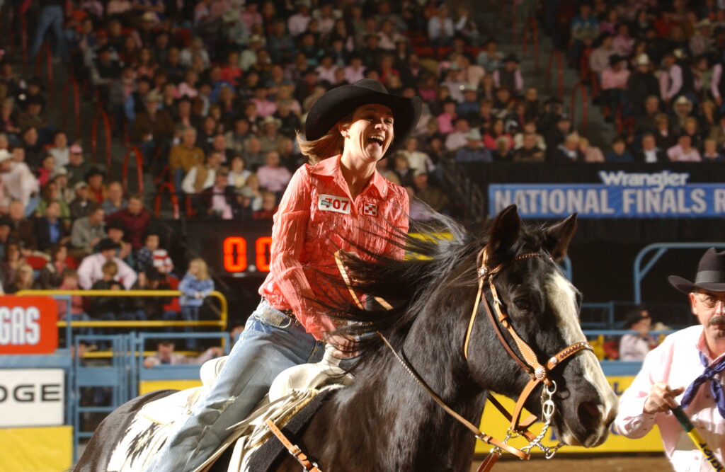 Kelly Maben smiles on horse during victory lap 