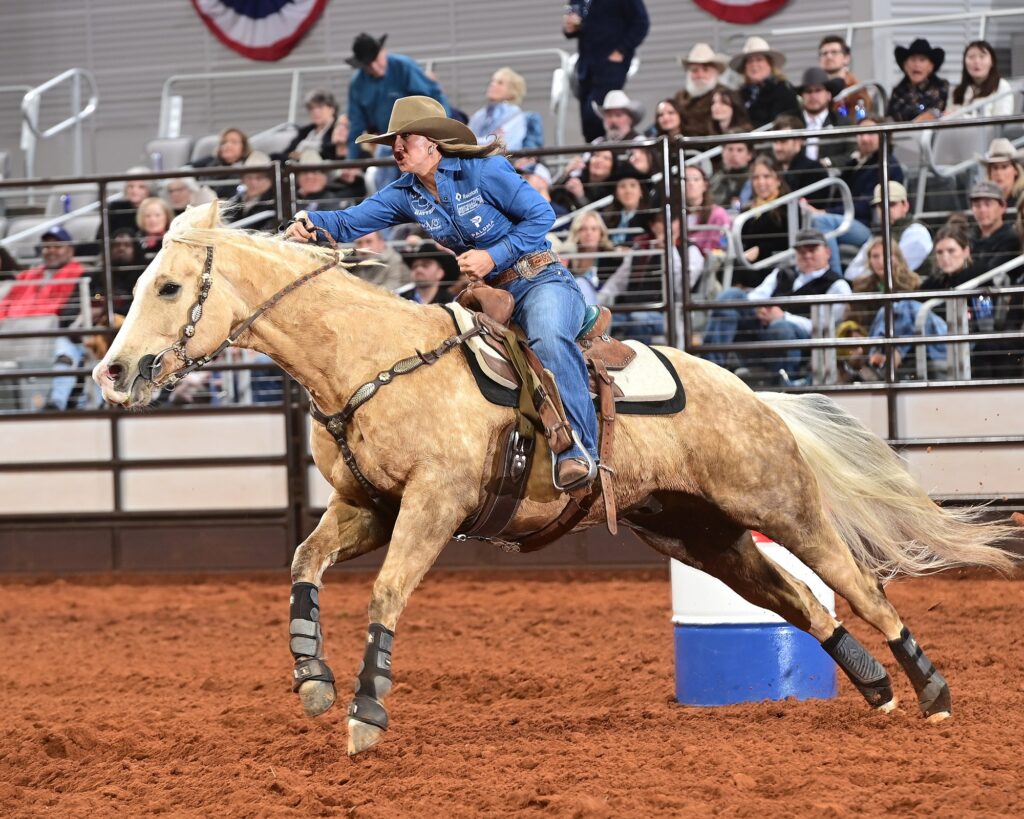 Katelyn Scott running barrels at FWSSR on Peanut Seed the horse