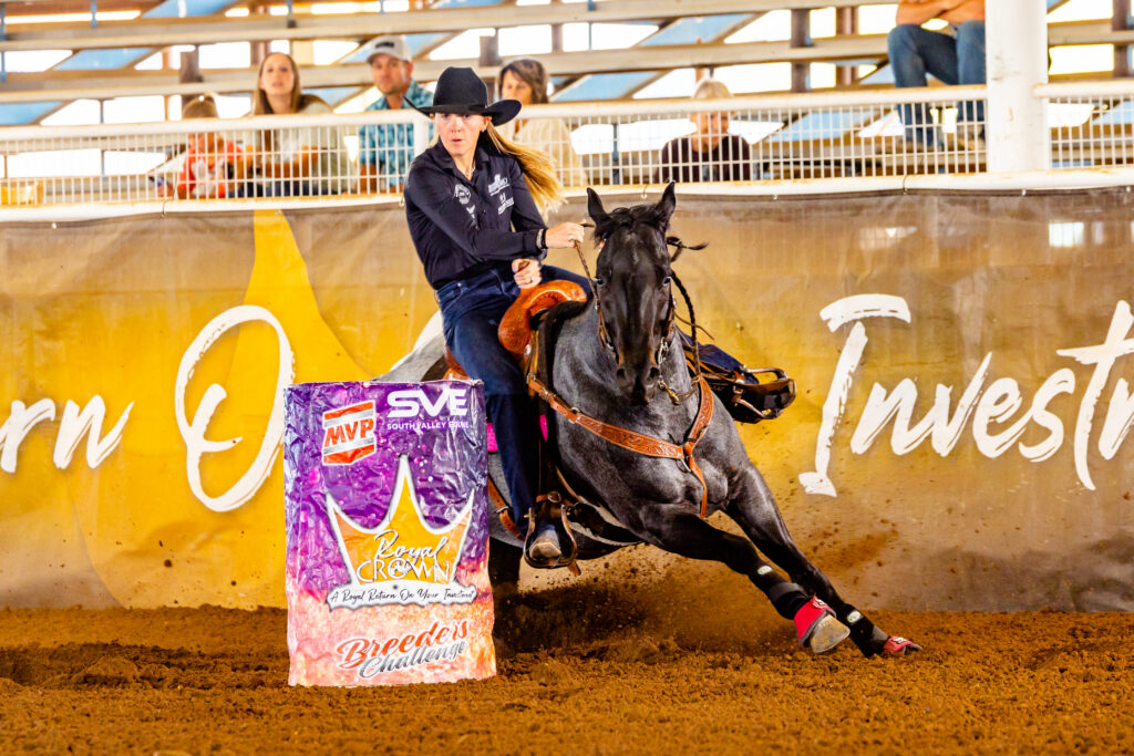 Ceri Ward rounds a barrel on her blue roan barrel horse
