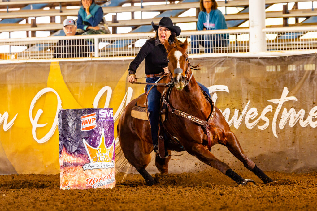 Terri Wood Gates aggressively turns a barrel on her horse
