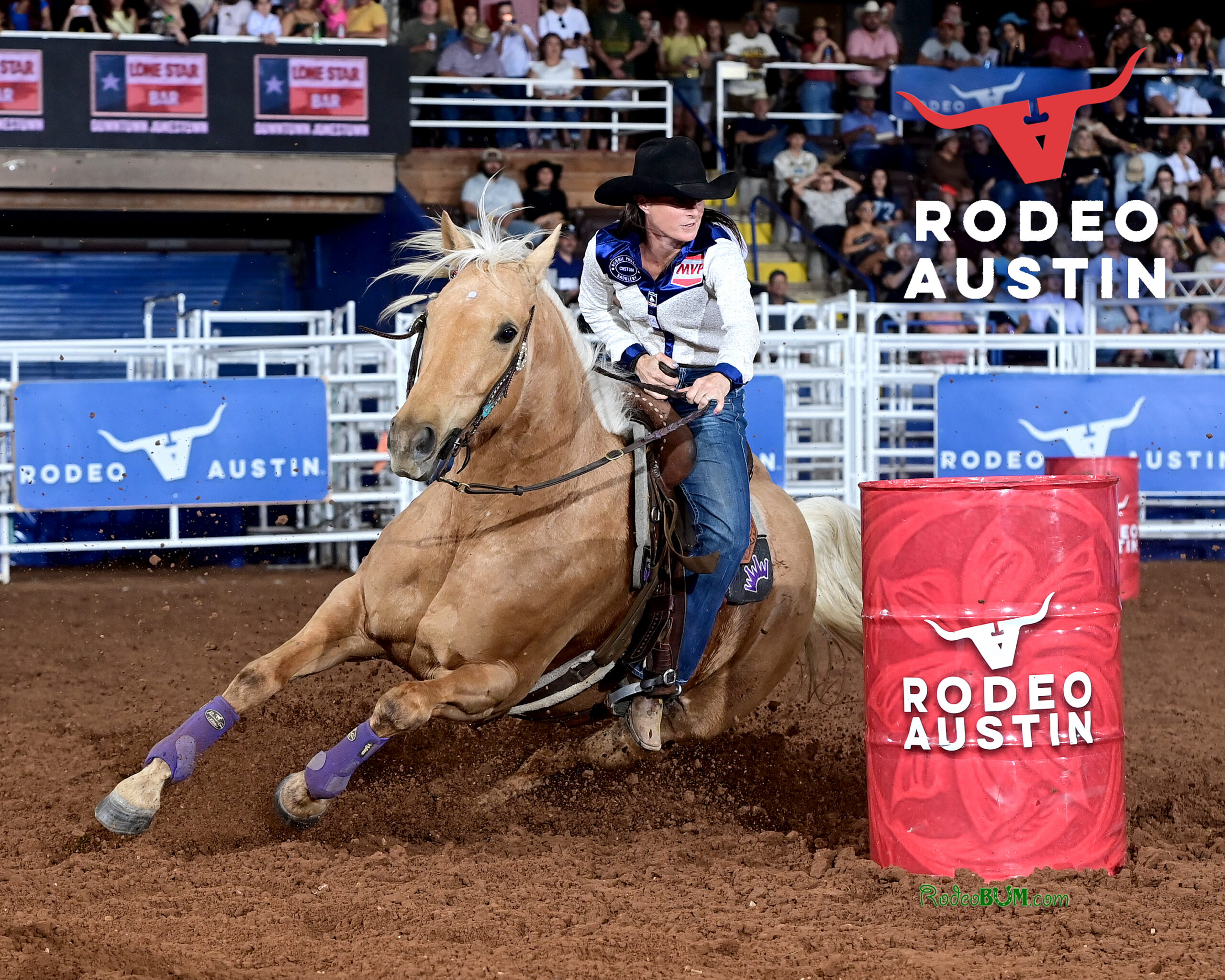 Hayle Stillwell turns a barrel on a yellow horse at Rodeo Austin