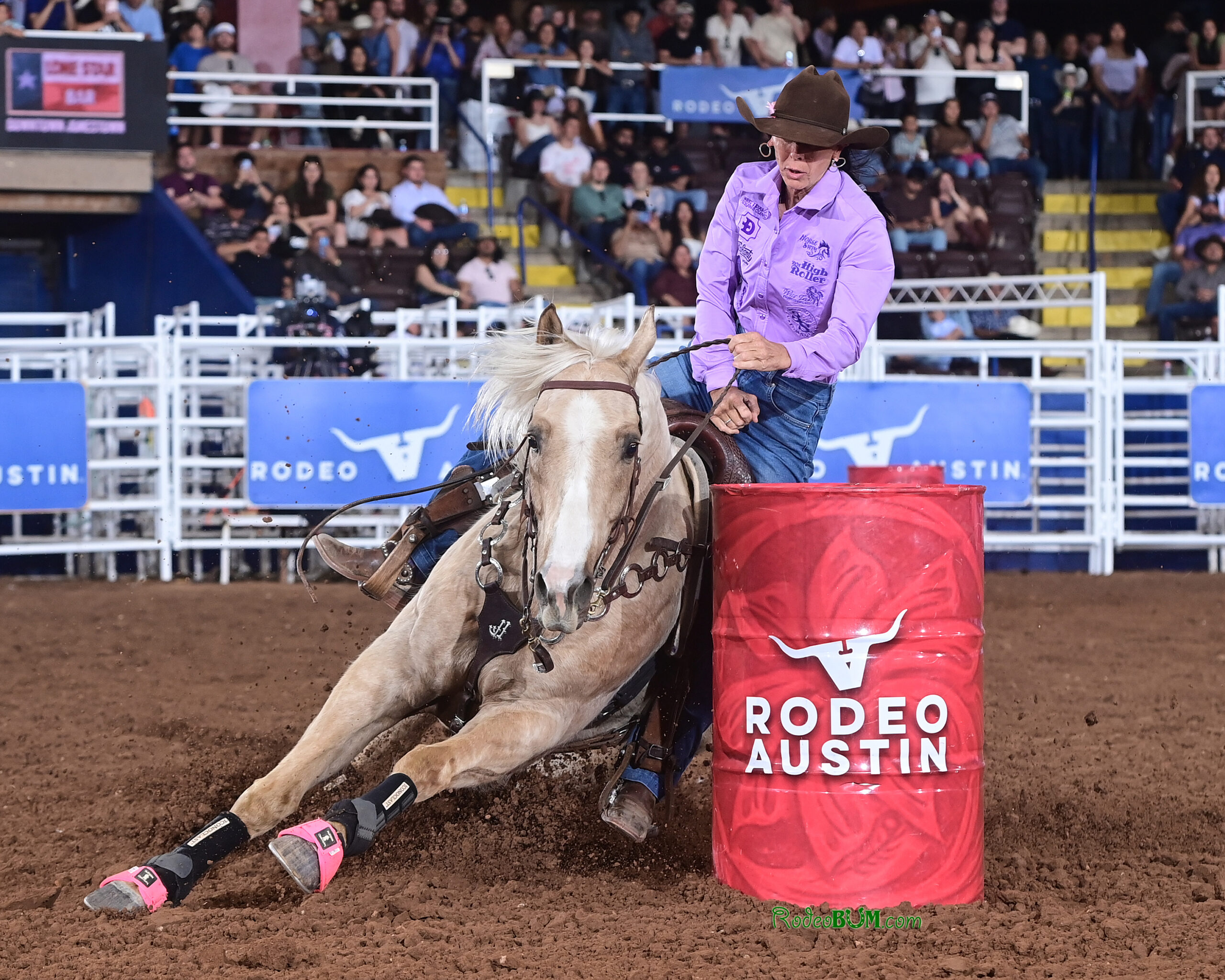 Latricia Duke and Carlos turn a red Rodeo Austin barrel