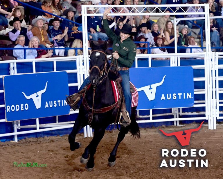 Kassie Mowry waves to the Austin crowd during a victory lap