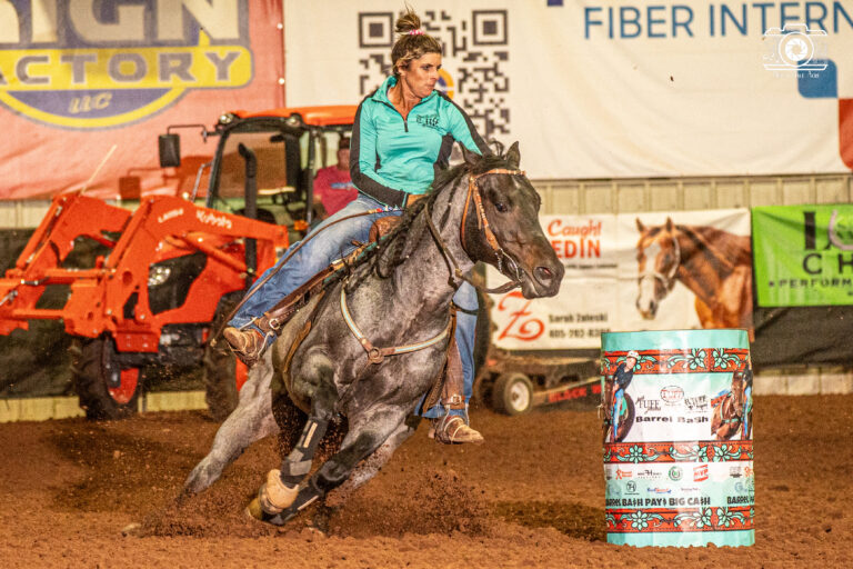 Tana Renick turns a barrel on her blue roan horse "Fonzie"