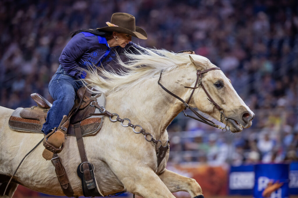 Latricia Duke runs home on her yellow horse Carlos as he strides out